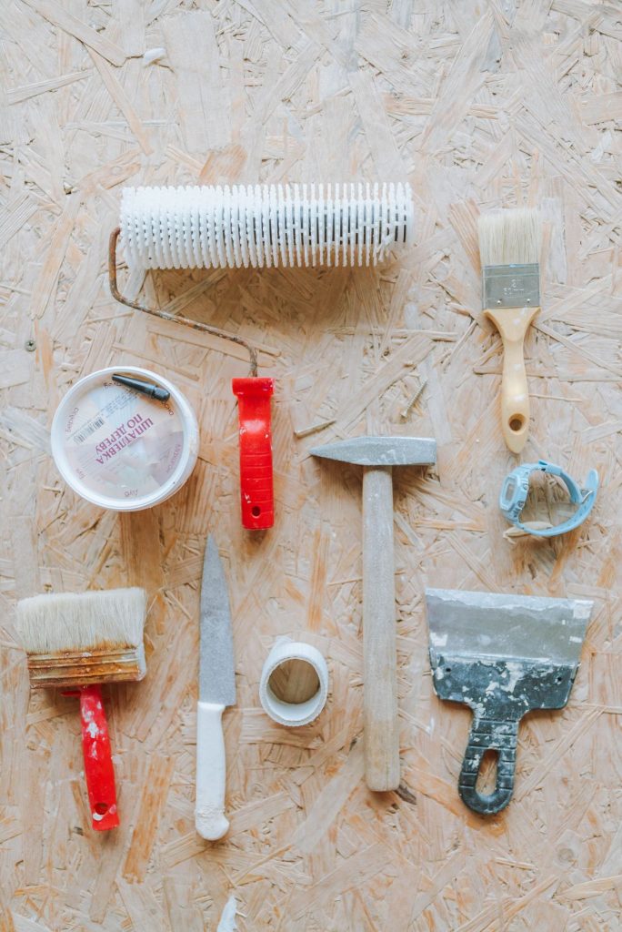 Tools for installing removable wallpaper: tape measure, level, utility knife and smoother