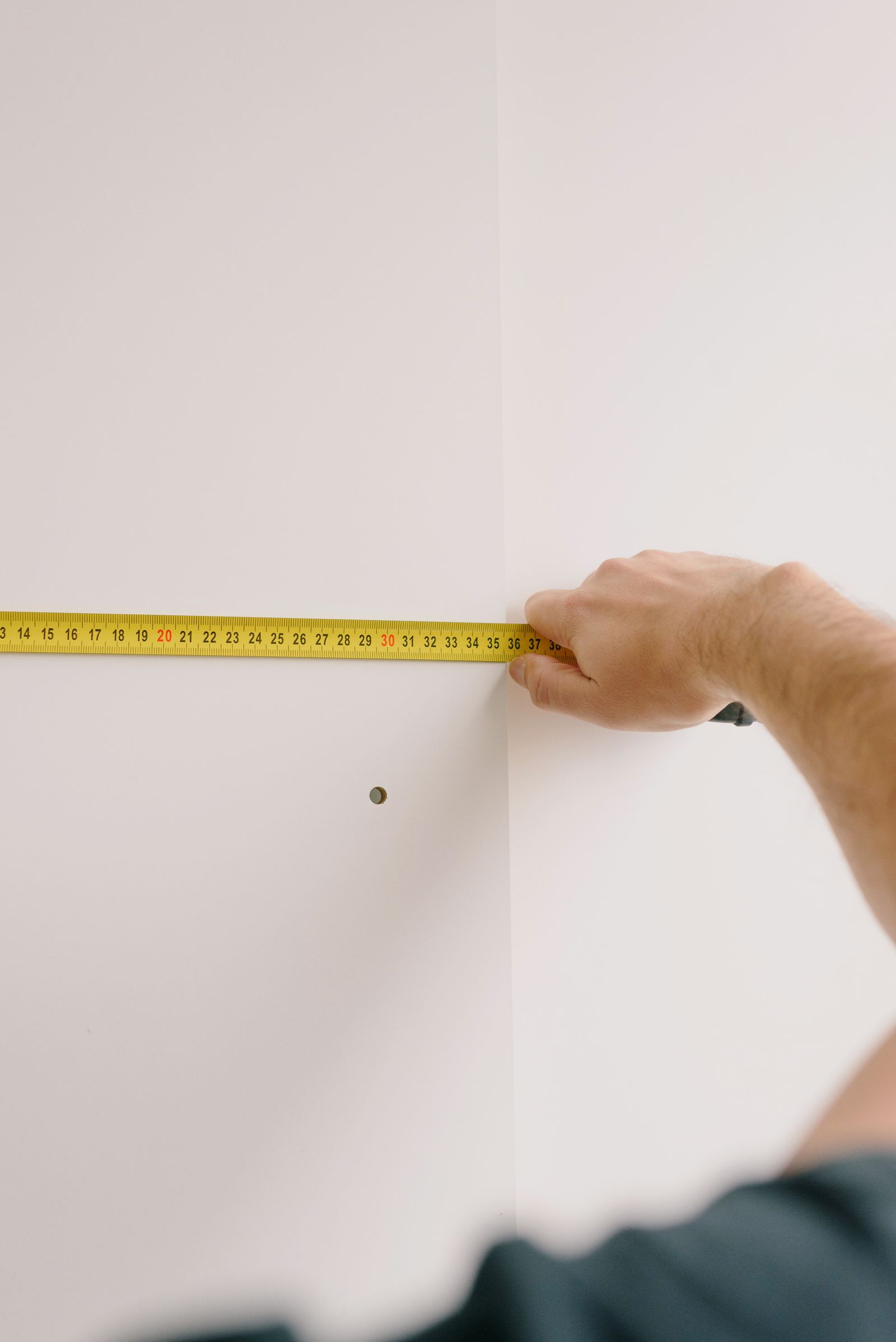 Measuring the height of a framed picture hung above a sofa